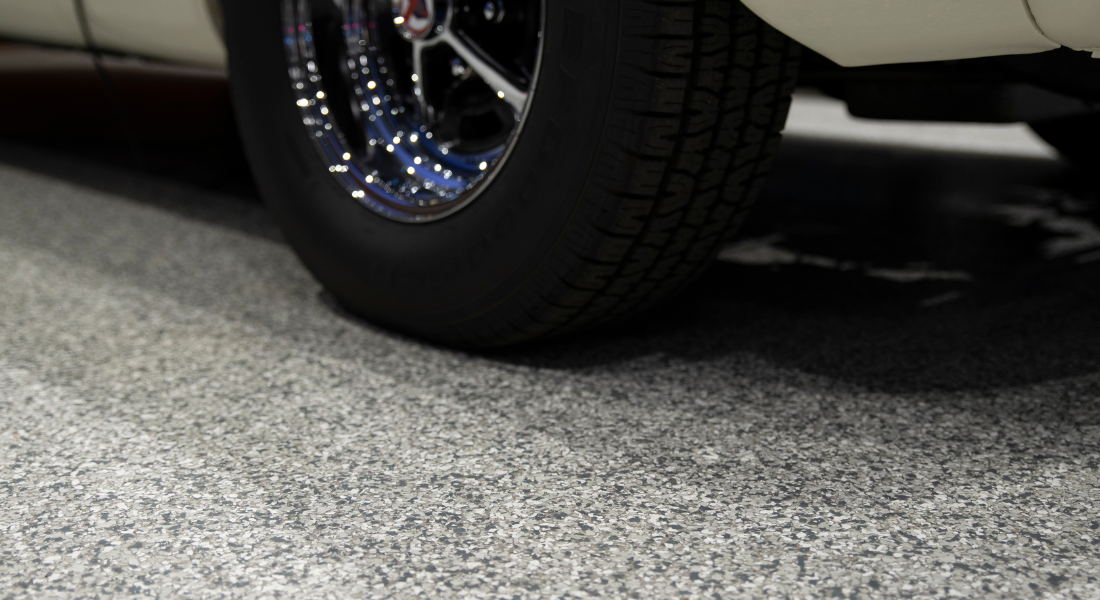A brand new car tire on a clean garage epoxy floor, Kelowna, BC