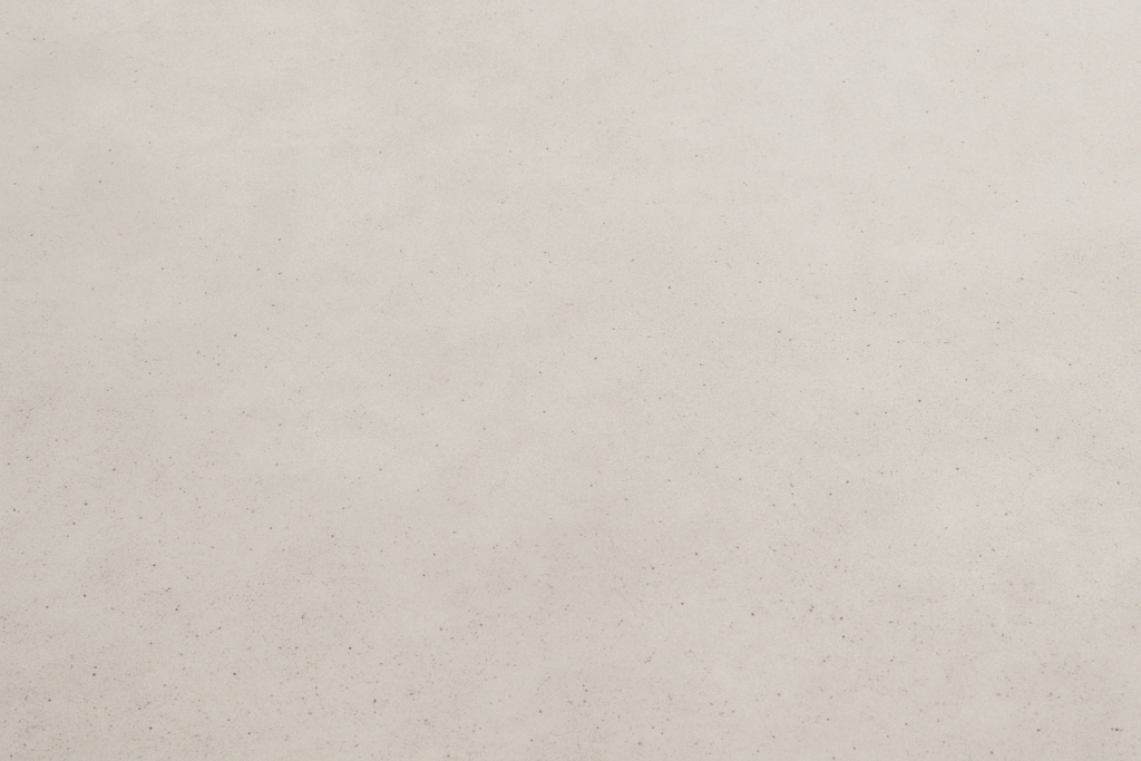 Image showing a smooth, light-colored cream finish for polished concrete, highlighting a subtle, refined surface with minimal texture.