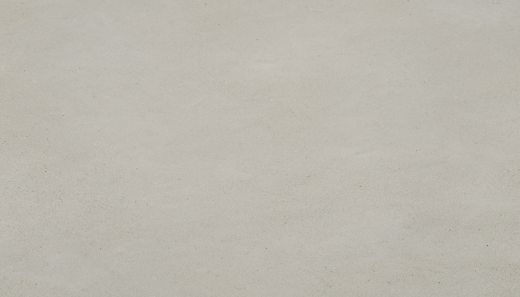 Smooth cream-finish polished concrete with minimal aggregate exposure and a uniform surface texture