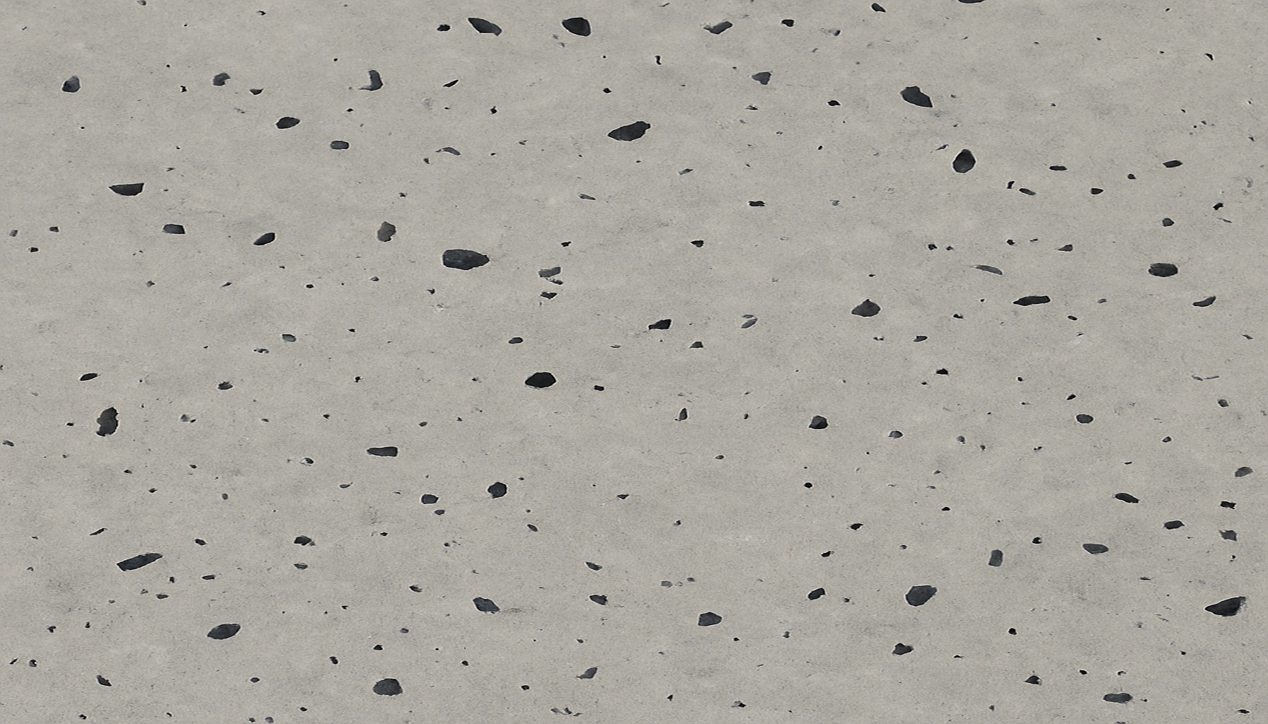 Lightly speckled salt and pepper polished concrete showing small aggregate flecks on a smooth grey surface