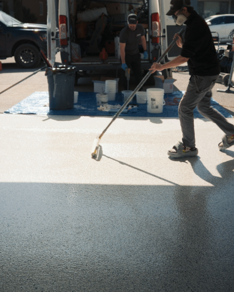 Prime Concrete Coatings technician applying epoxy to a garage floor in Kelowna