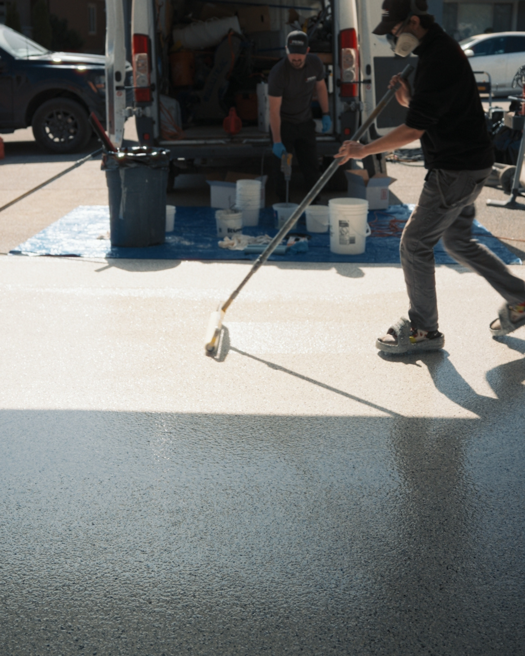 Prime Concrete Coatings technician applying epoxy to a garage floor in Kelowna