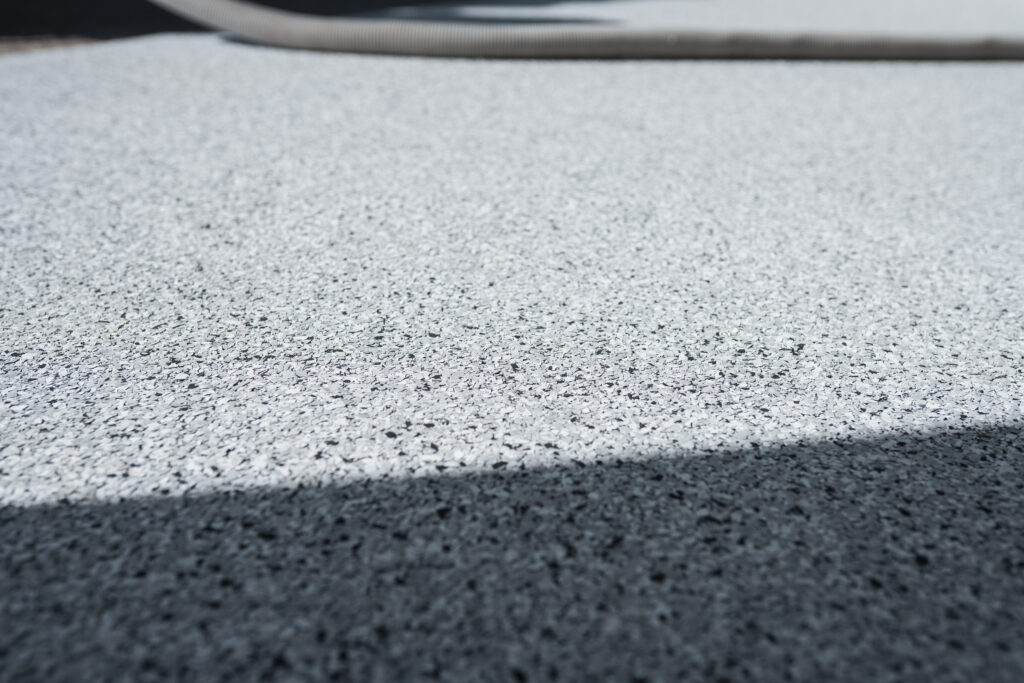 Epoxy Flake Flooring System installed in Kelowna garage by Prime Concrete Coatings
