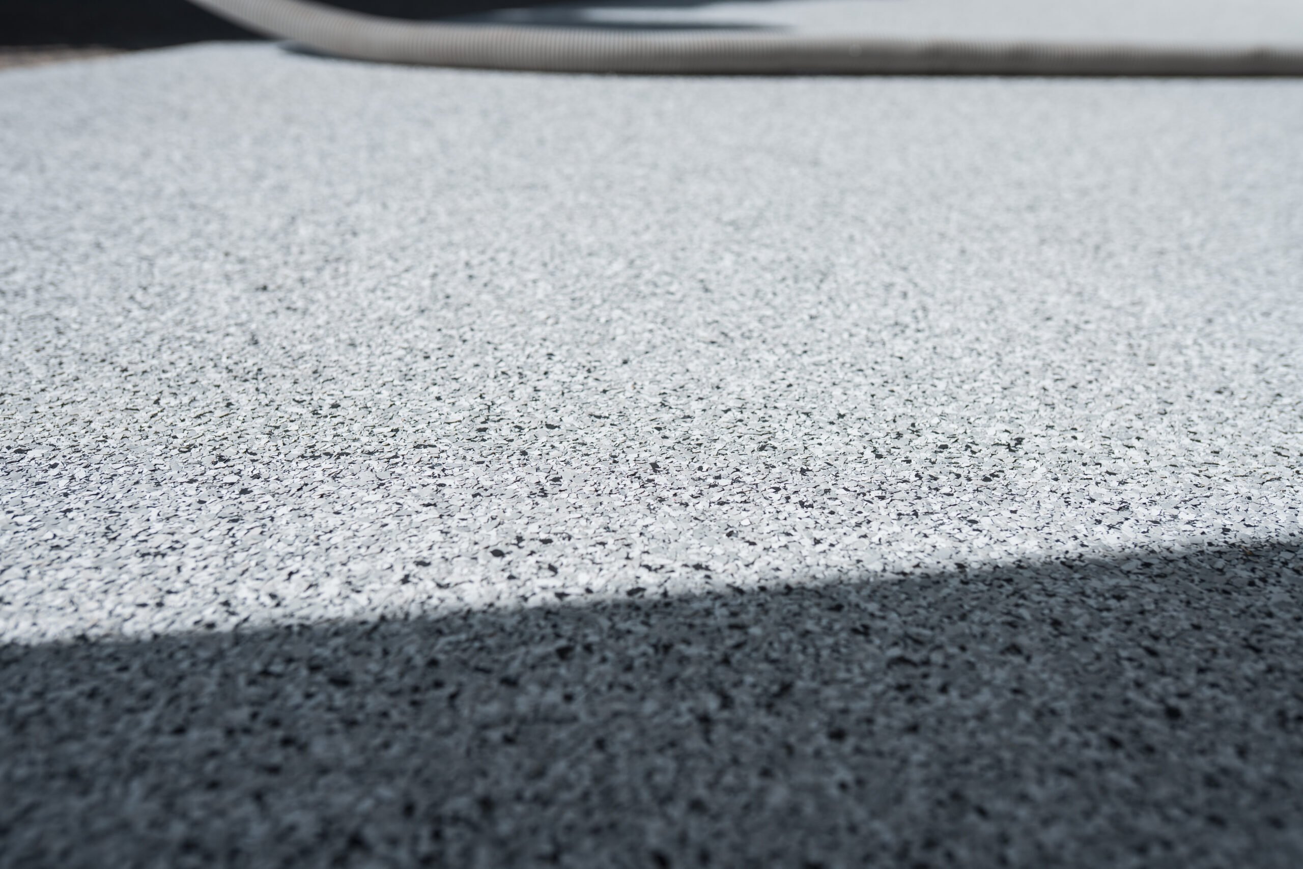 Epoxy Flake Flooring System installed in Kelowna garage by Prime Concrete Coatings