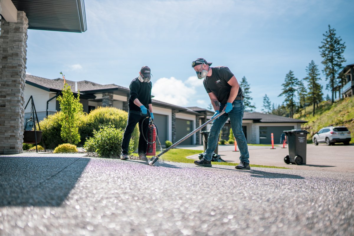 Prime Concrete Coatings technicians applying sealer to driveway in Kelowna